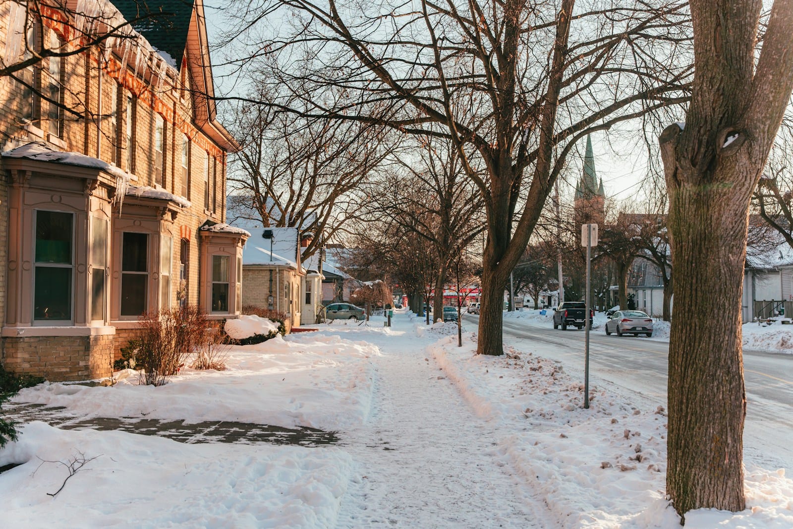 Cleared sidewalk on a snowy residential street
